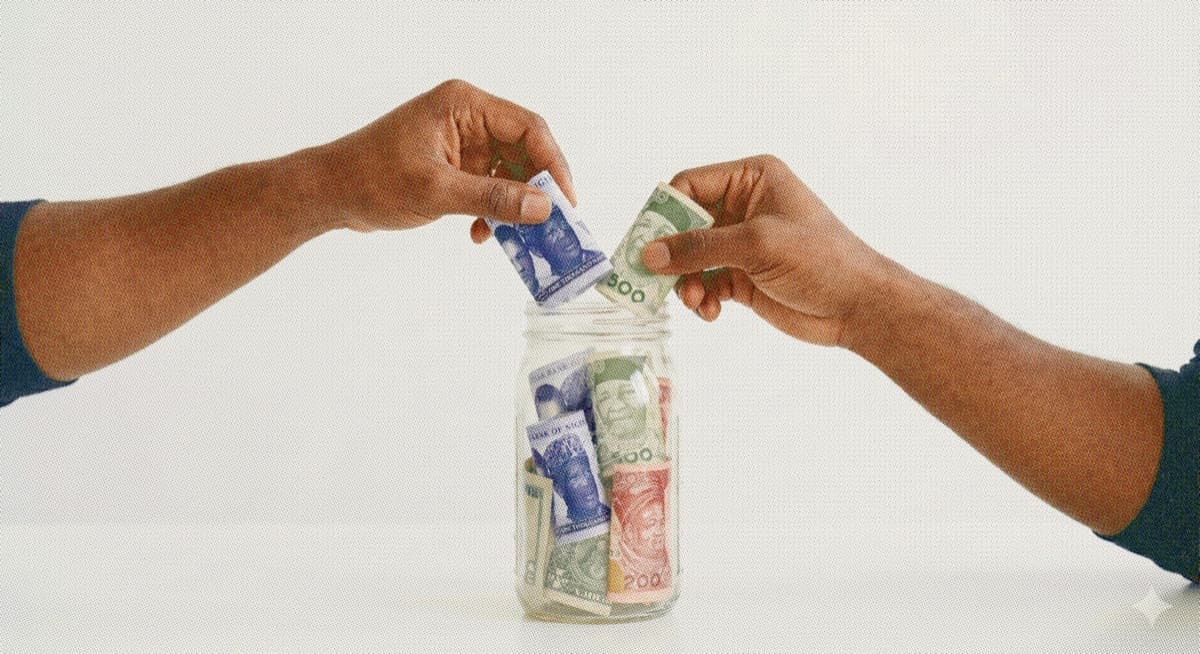 Hands placing Naira notes into a glass jar of mixed banknotes